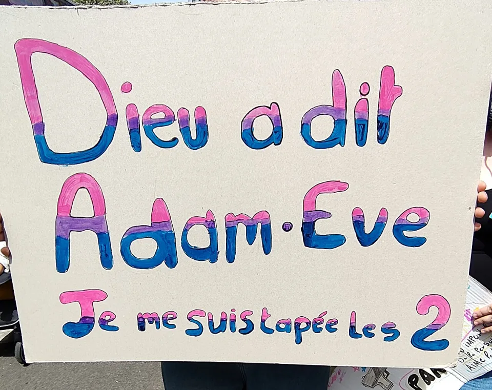 Protest sign reading “Dieu a dit Adam et Ève, je me suis tapée les deux” at “Nantes Pride — 13 June 2026” in Nantes, France.