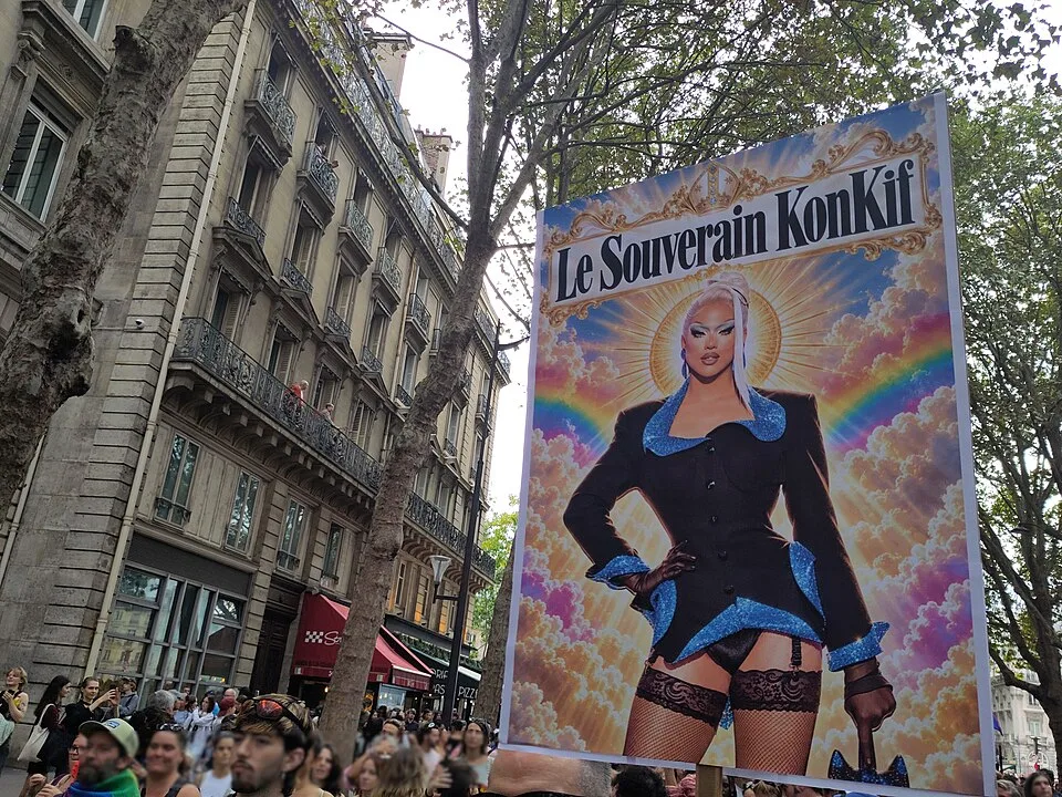 Protest sign reading “Le Souverain KonKif” at “Paris Pride — 3 October 2026” in Paris, France.