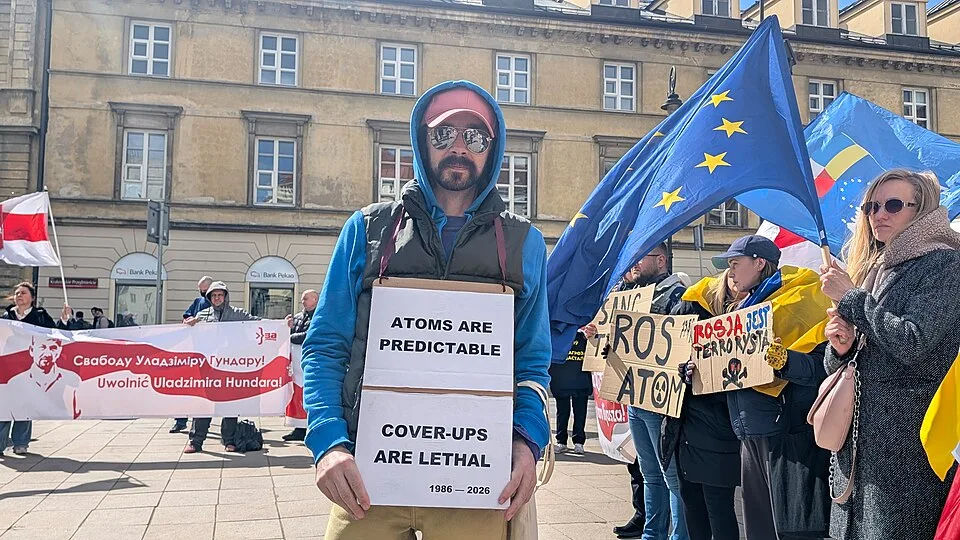 Protest sign reading “Atoms are predictable. Cover-ups are lethal. 1986–2026” at “Chernobyl Way — Warsaw, 26 April 2026” in Warszawa, Poland.