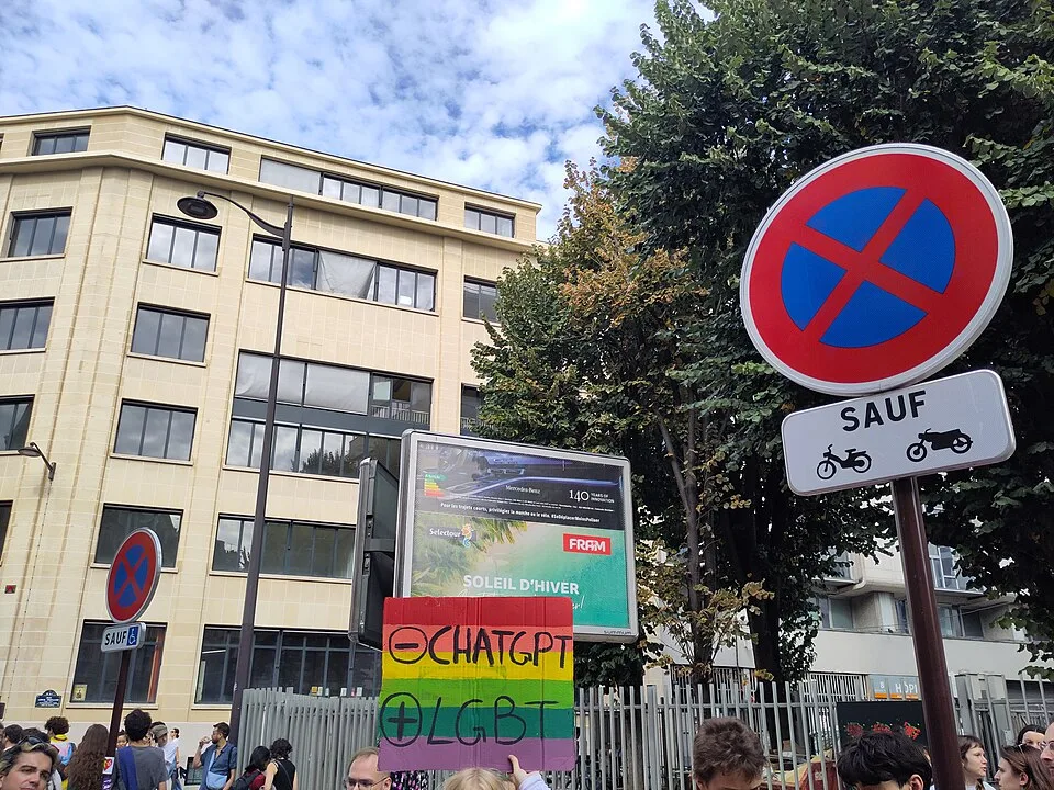 Protest sign reading “− ChatGPT, + LGBT” at “Paris Pride — 3 October 2026” in Paris, France.