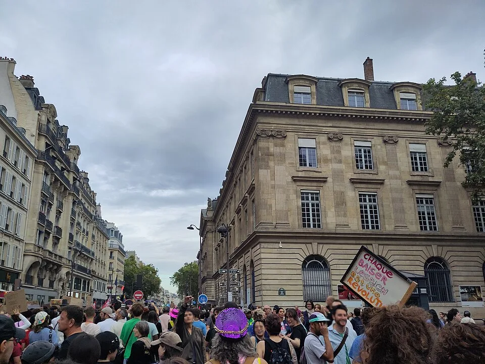 Protest sign reading “Chaque baiser lesbien est une révolution” at “Paris Pride — 3 October 2026” in Paris, France.