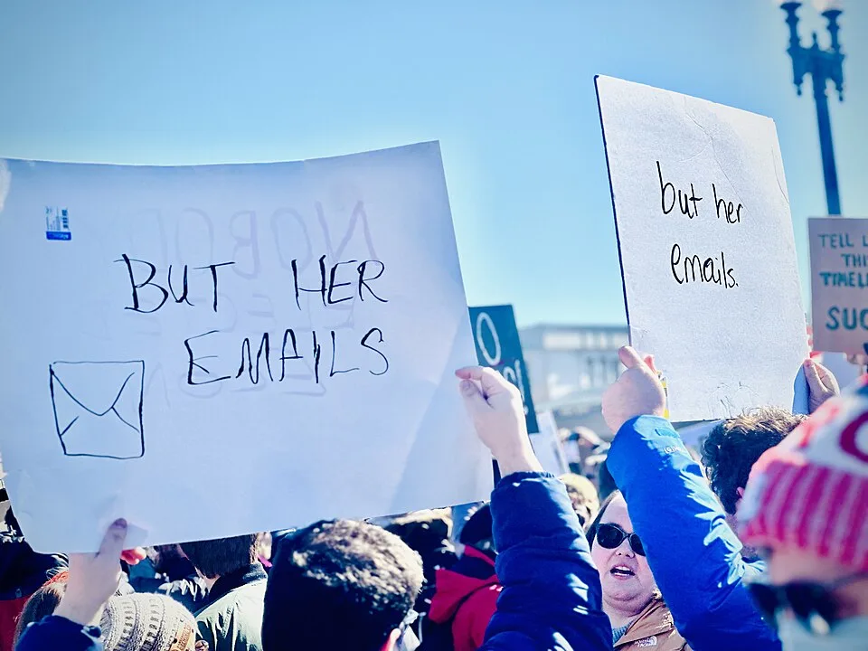 Protest sign reading “But her emails”