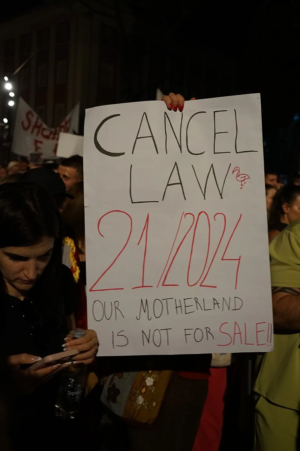 Protest sign reading “Cancel Law C1/2024. Our motherland is not for sale!”, photographed in Tirana, Albania.