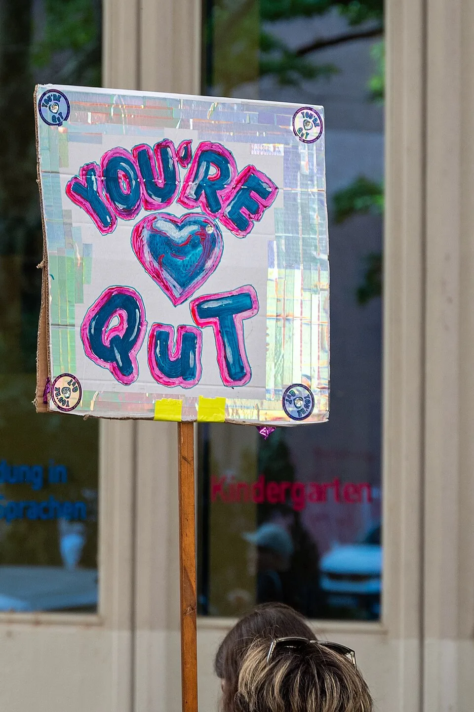 Protest sign reading “You're QuT”