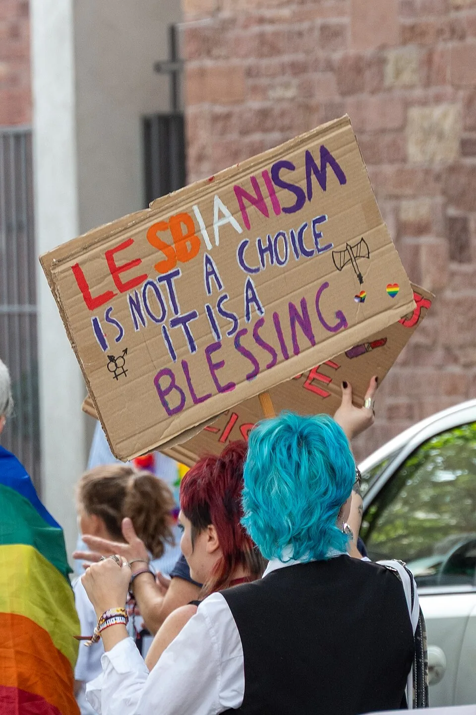 Protest sign reading “Lesbianism is not a choice, it is a blessing”