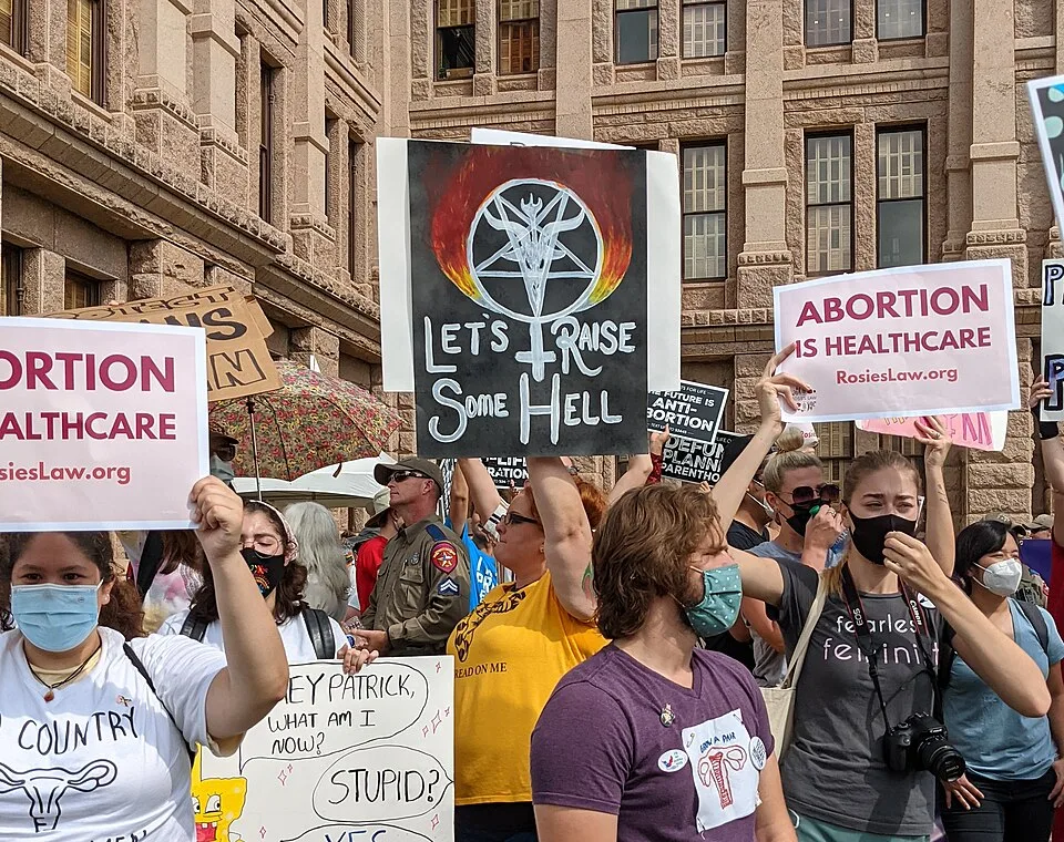 لافتة احتجاج مكتوب عليها «Let's raise some hell»