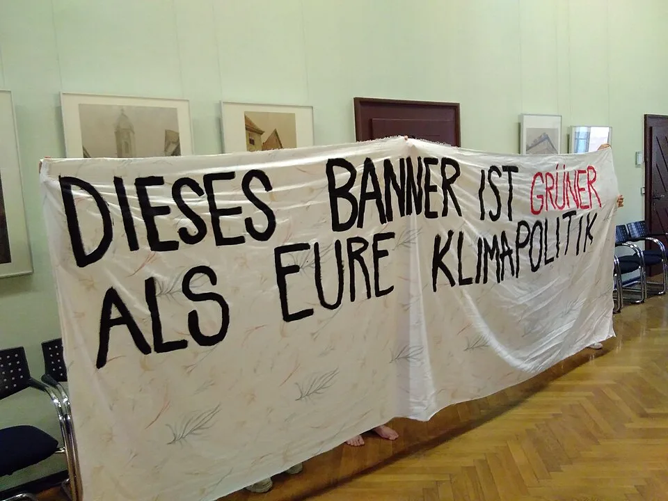 لافتة احتجاج مكتوب عليها «Dieses Banner ist grüner als eure Klimapolitik»