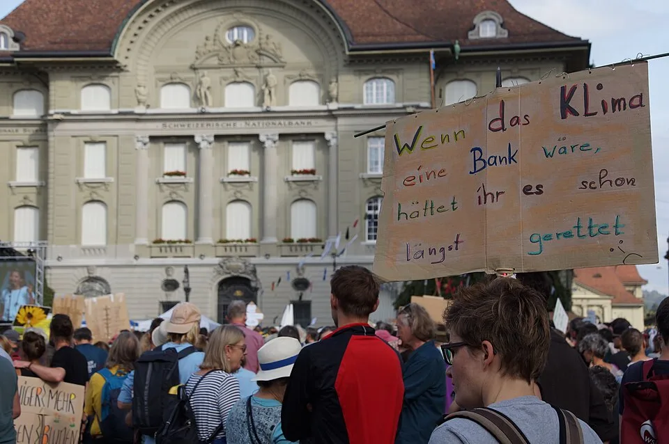 Pancarta con el texto «Wenn das Klima eine Bank wäre, hättet ihr es schon längst gerettet», fotografiada en Bern, Suiza.