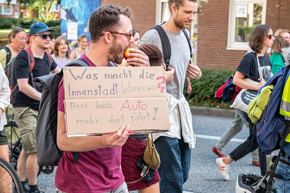 Pancarta de protesta que dice «Was macht die Innenstadt lebenswert? Dass kein Auto mehr dort fährt!»