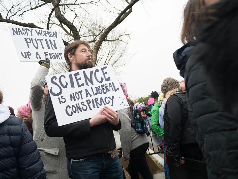 Protest sign reading “Science is not a liberal conspiracy”, photographed in Washington, United States.