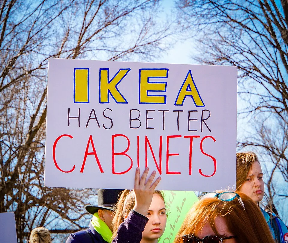 Protest sign reading “IKEA has better cabinets”, photographed in Washington, United States.