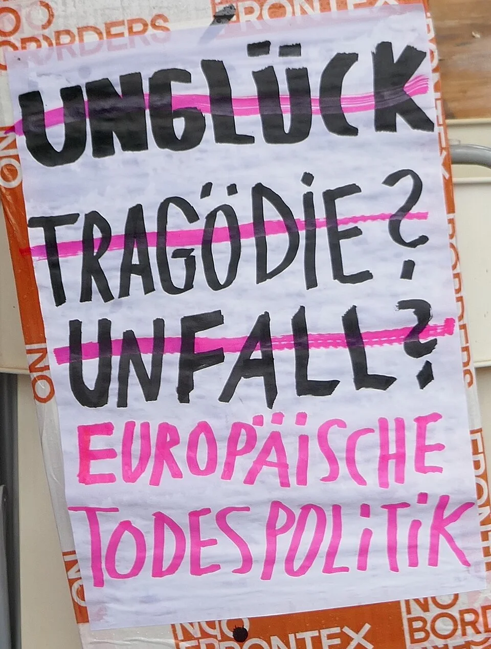 Protest sign reading “Unglück? Tragödie? Unfall? Europäische Todespolitik”, photographed in Bern, Switzerland.